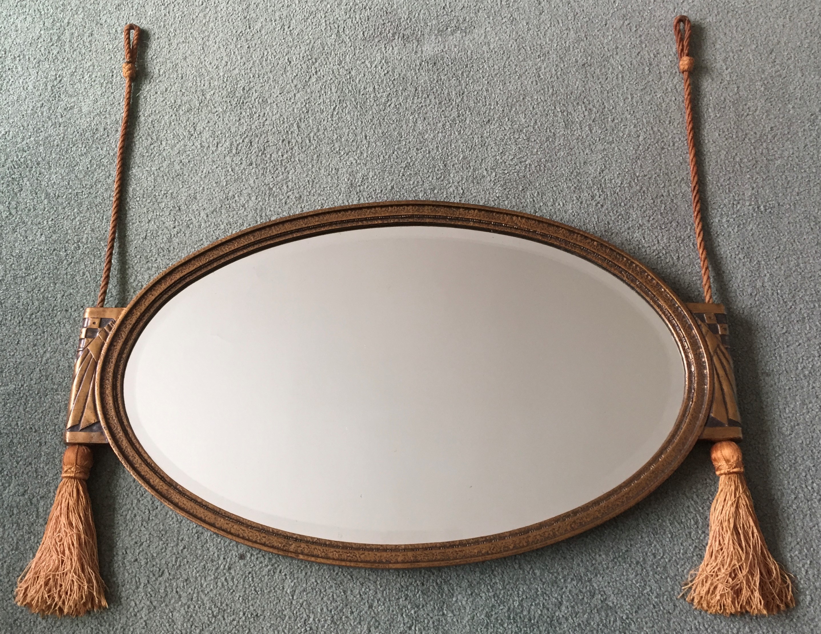 An Art Deco style oval wall mirror, width 74cm, height 43cm